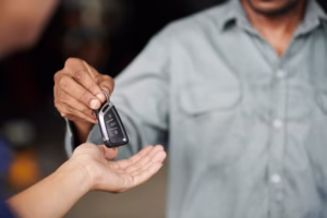 Mechanic Giving Car Keys Closeup image of mechanic giving car keys to client